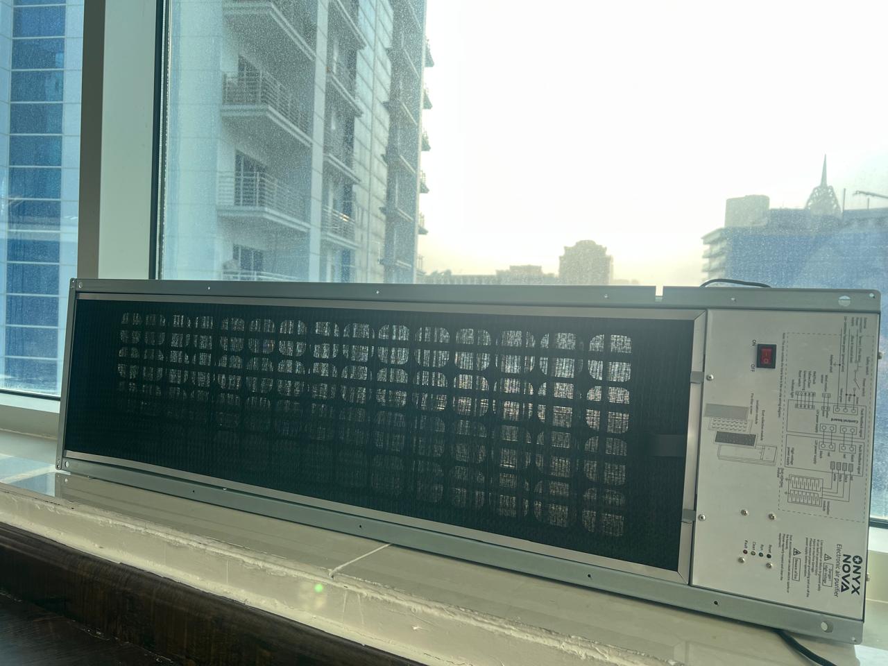 Slim ONYX Aura electrostatic purification module fitted at the return-air side of an air-conditioning unit.